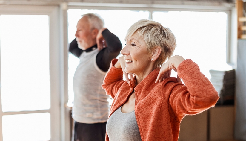 Older adults exercising at home as part of a healthy and active retirement routine.