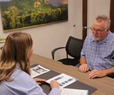 Medicare beneficiary meeting with a local Medicare agent to review plan options during Annual Enrollment.
